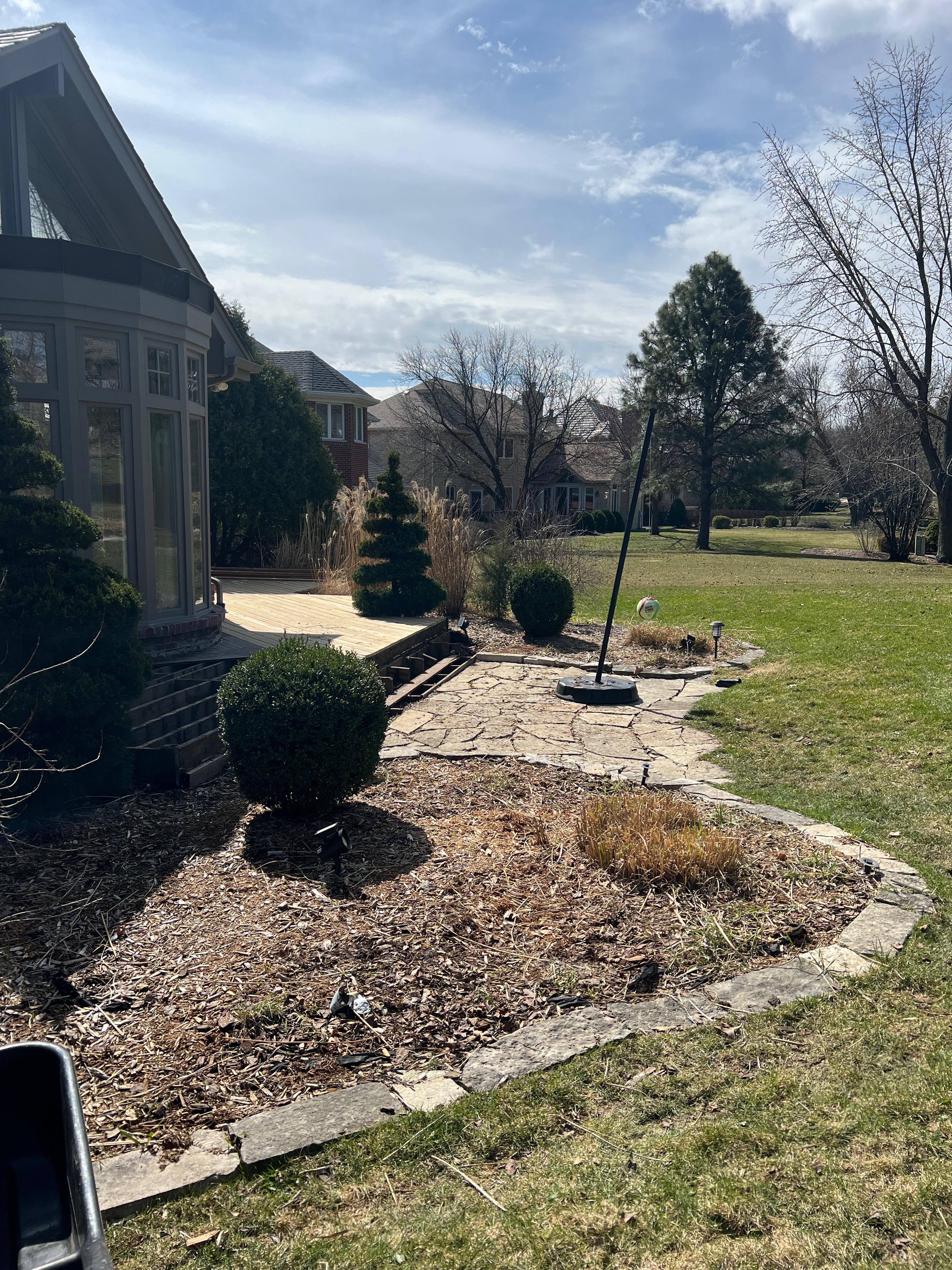 A pile of discarded furniture including a sofa, chair, and various cushions on a city sidewalk, highlighting urban waste and the need for proper disposal or recycling