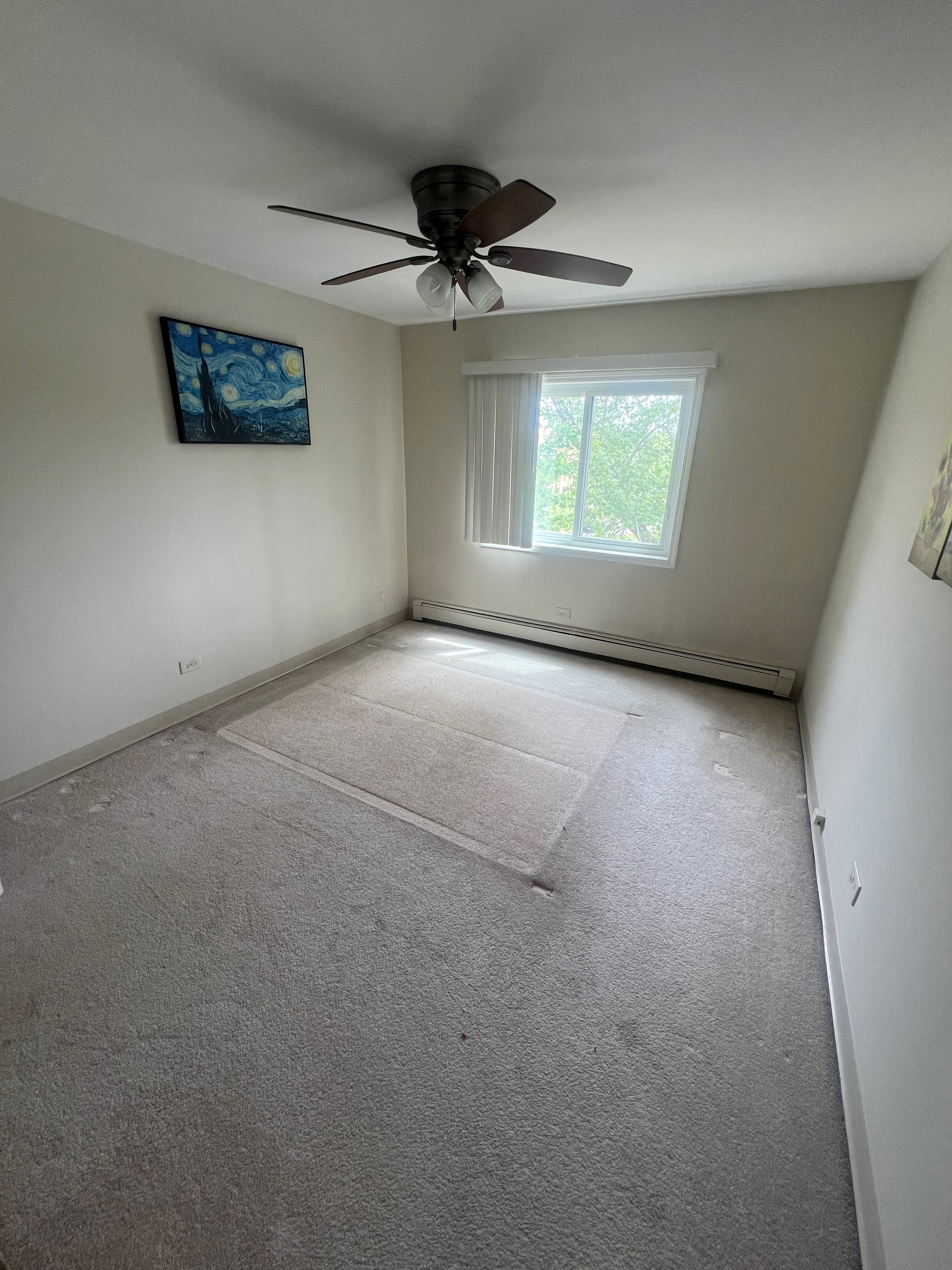 Garbage truck picking up trash bins on suburban street side.